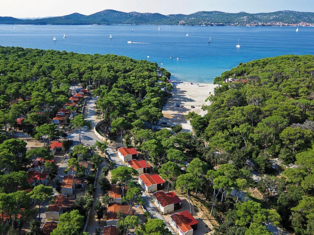 an aerial view of a beach with houses and trees at Victoria Mobilhome Camping Park Soline in Biograd na Moru