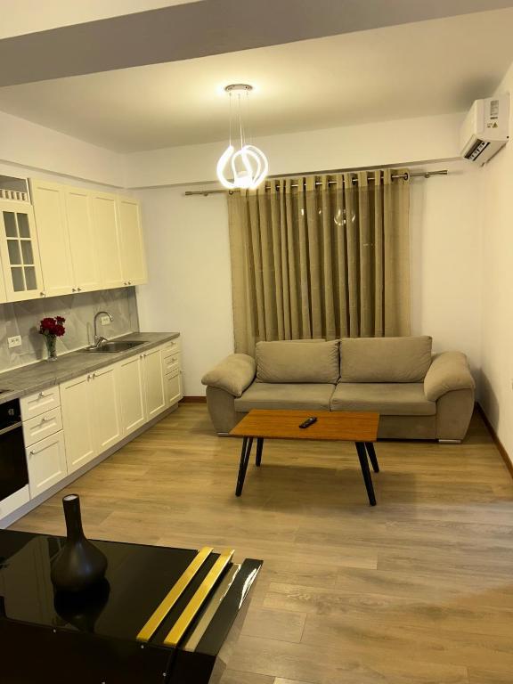 a living room with a couch and a coffee table at Flat in Tirana - Modern & Cozy in Tirana