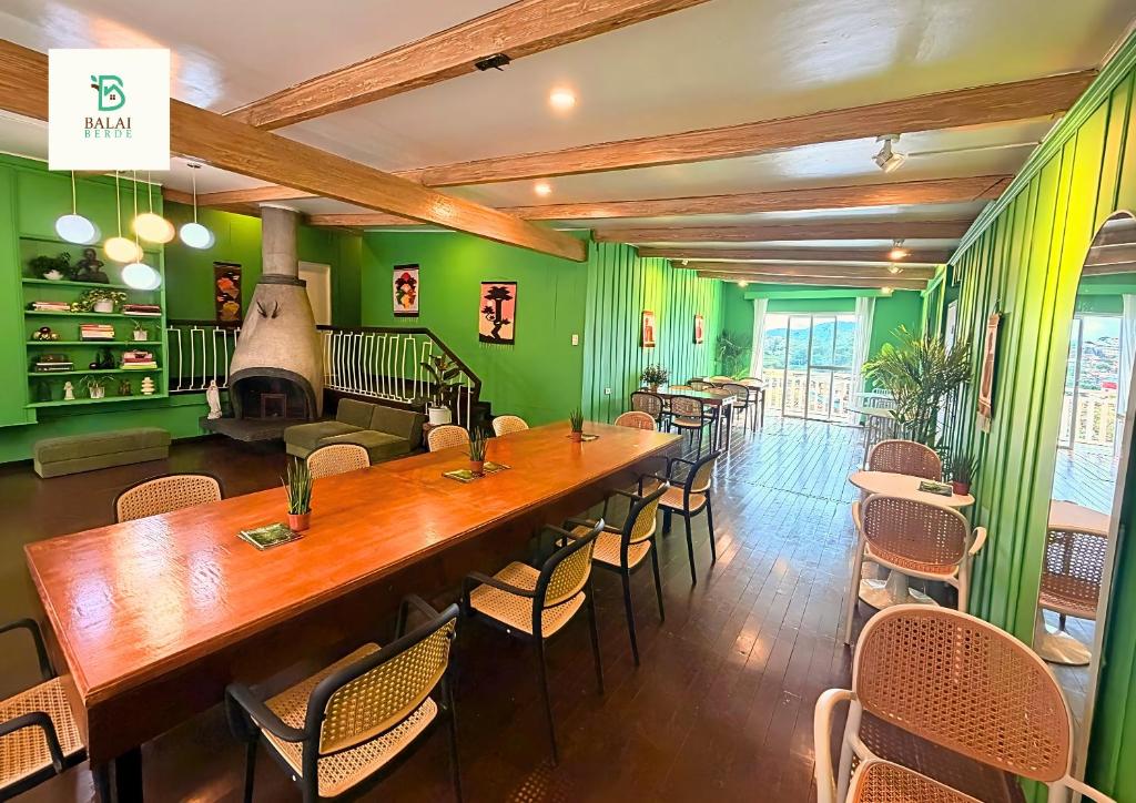 a room with a long wooden table and chairs at Balai Berde Baguio in Baguio