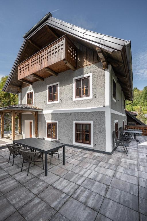 a house with a ping pong table in front of it at Ferienhaus zur Hackenschmiede in Mauterndorf