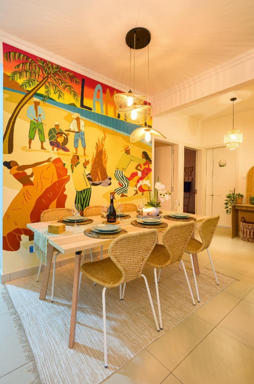 a dining room with a table and chairs at Lamarel Beach House 2 in Flic-en-Flac