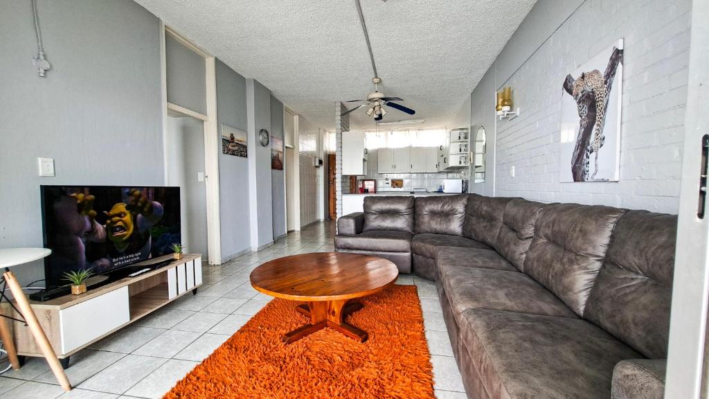 a living room with a couch and a table at Seagull 505 in Margate