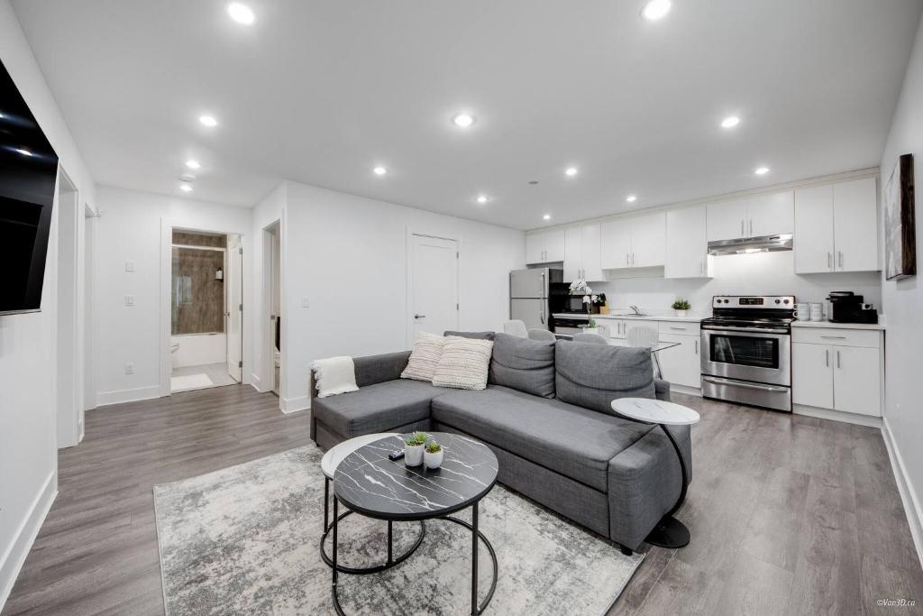 a living room with a couch and a table at Modern 2Bed Suite Near Capilano Bridge & Trails in North Vancouver