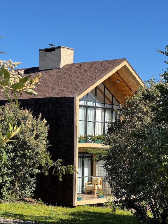 a house with a large window on the side of it at Idan Barn Suites & Café in Naro Moru