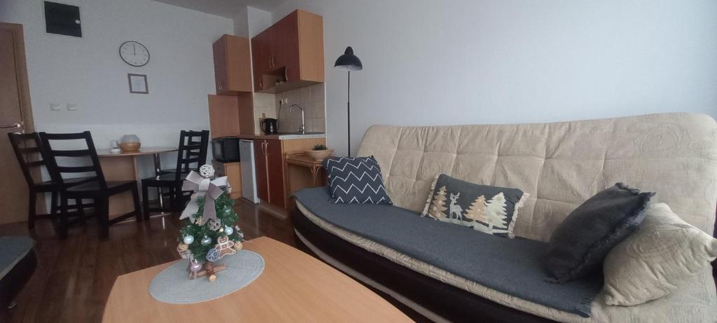 a living room with a couch and a christmas tree on a table at Divčibare Snežna Kraljica ap 13 in Divčibare