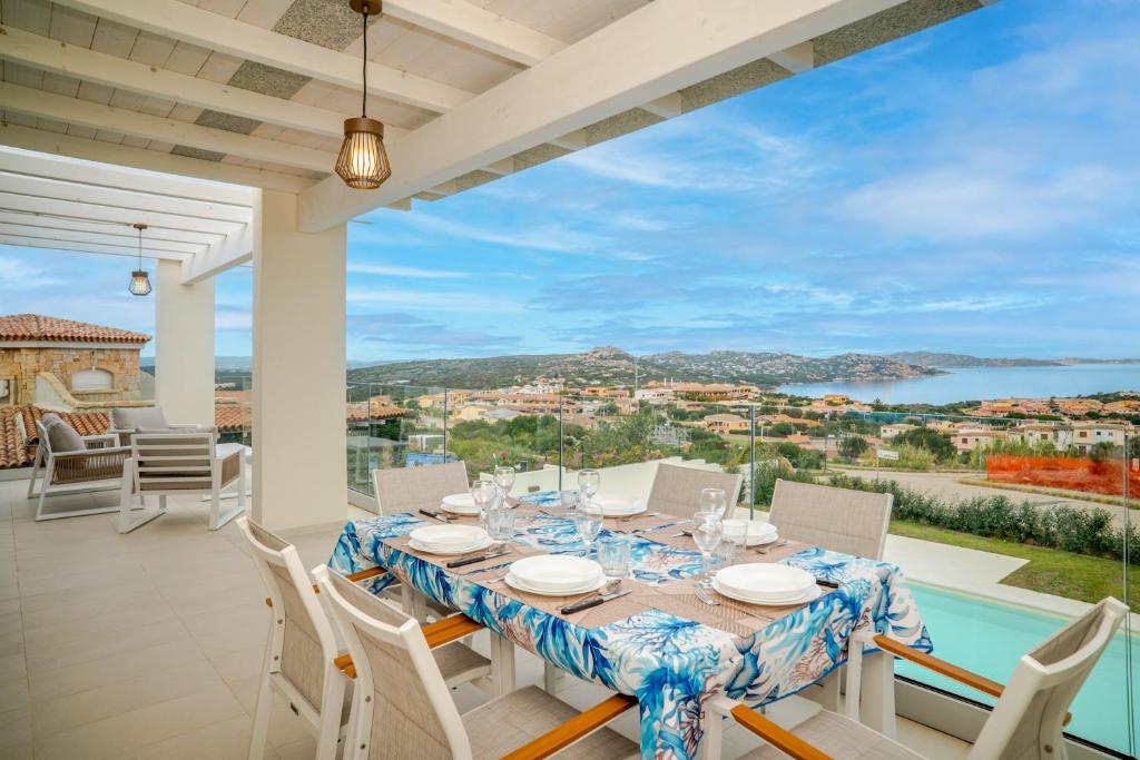a dining room with a table and chairs and a view at Smeraldo Apartment in Palau