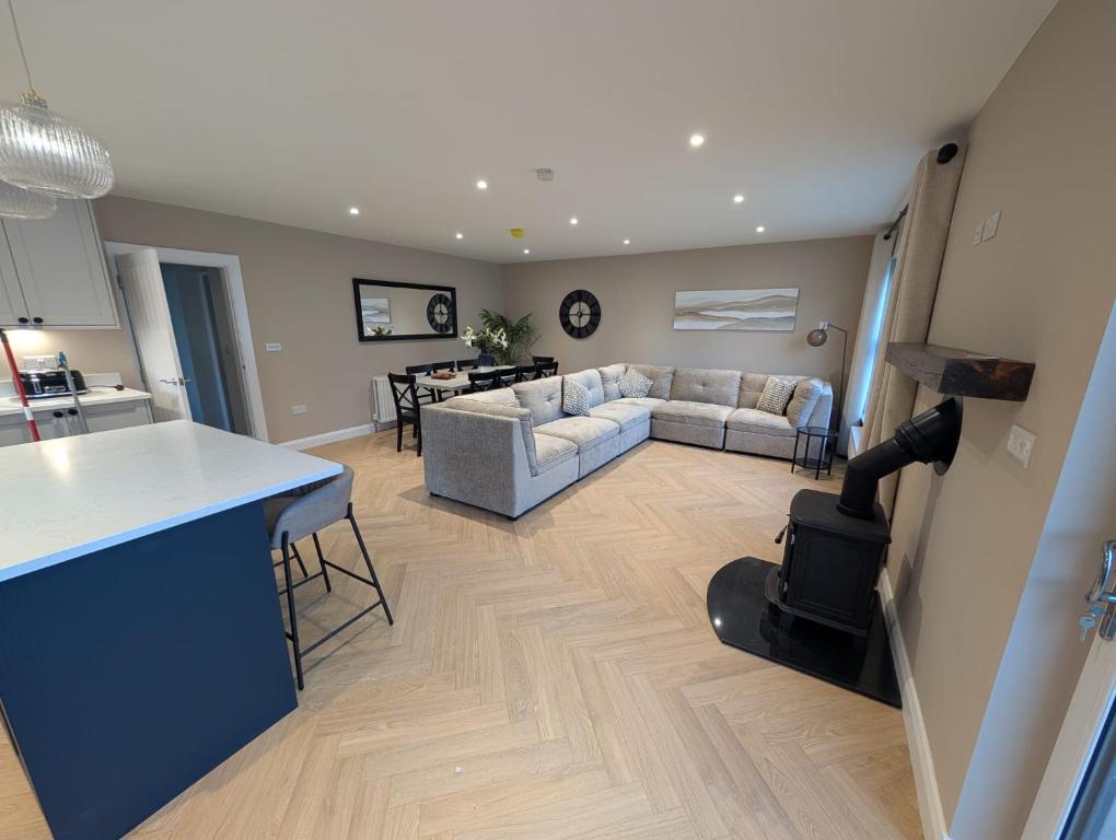 a kitchen and living room with a couch and a table at The Views Retreat in Newcastle