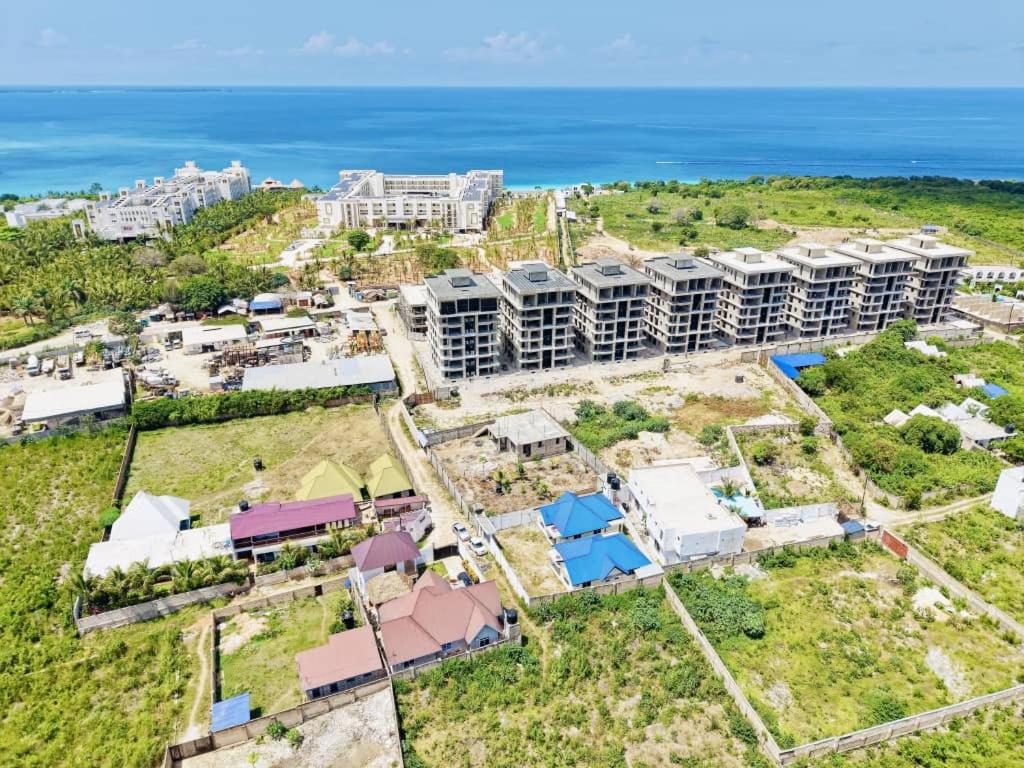 an aerial view of a resort with the ocean in the background at Swahili lodge nungwi in Kinyasini