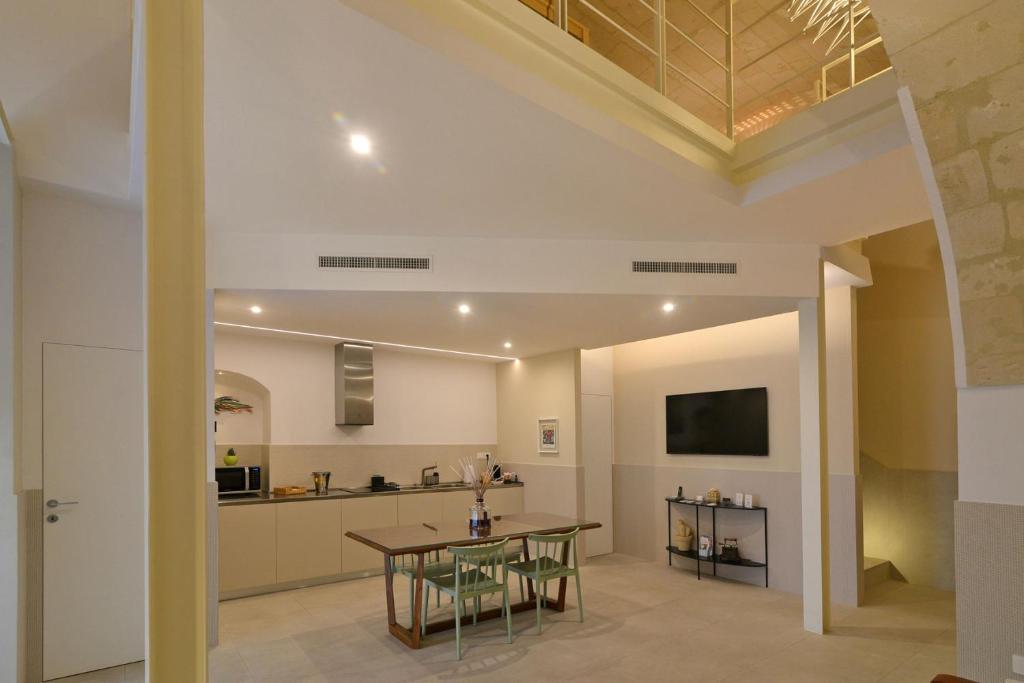 ein Esszimmer und eine Küche mit Tisch und Stühlen in der Unterkunft aMate' Luxury slow living by BarbarHouse in Matera
