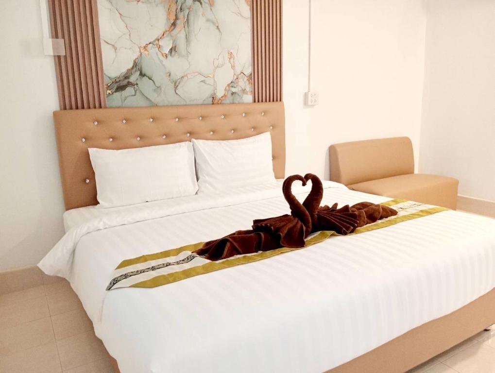 a bed with a towel on top of it at Lanta Beautiful beach house 2 in Phra Ae beach
