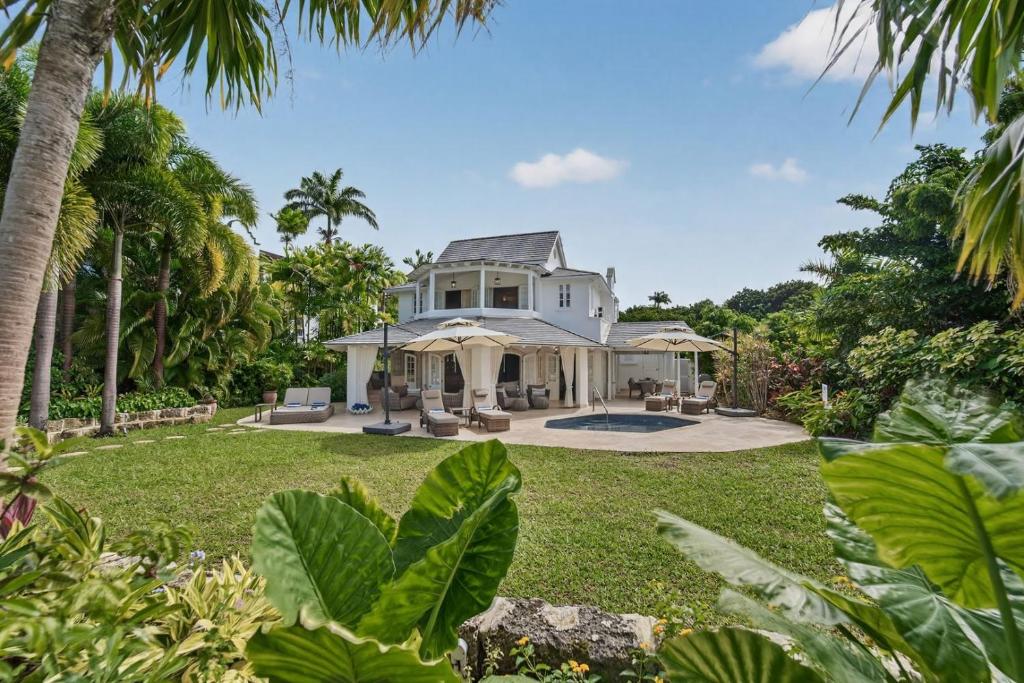 an exterior view of a house with palm trees at Royal Westmoreland - Villa Grove home in Saint James