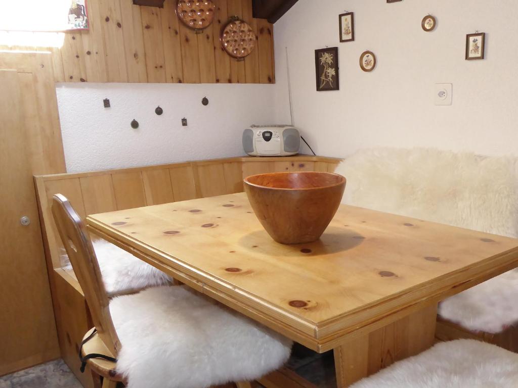 a wooden table with a bowl on top of it at Chalet Memory in Zermatt