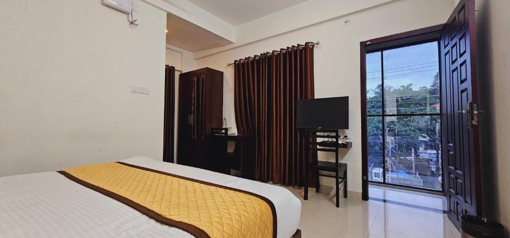 Postel nebo postele na pokoji v ubytování BLUEWAY RESIDENCY DOWNTOWN HOTEL