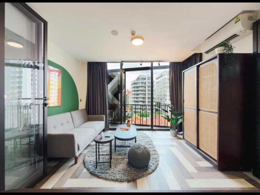a living room with a couch and a table at Quay 17 by Cove - Brand new serviced apartments - River Valley, Robertson Quay in Singapore