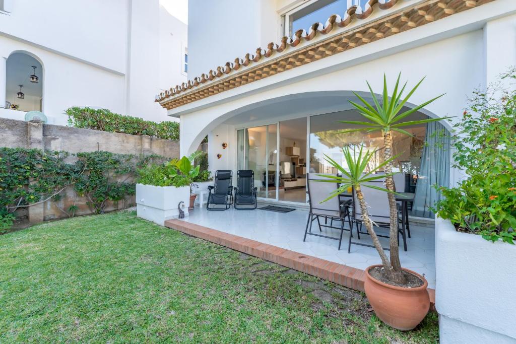 a house with a patio with a table and chairs at Luxury Villa Mijas Costa with Sea View in Mijas Costa