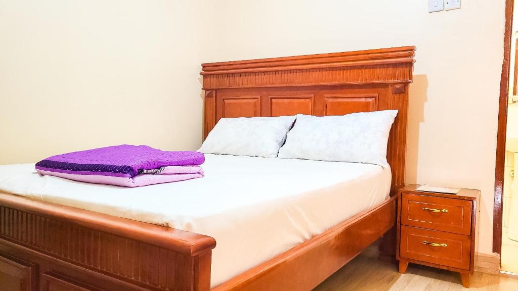 Rúm í herbergi á Nik Suites Nangabo