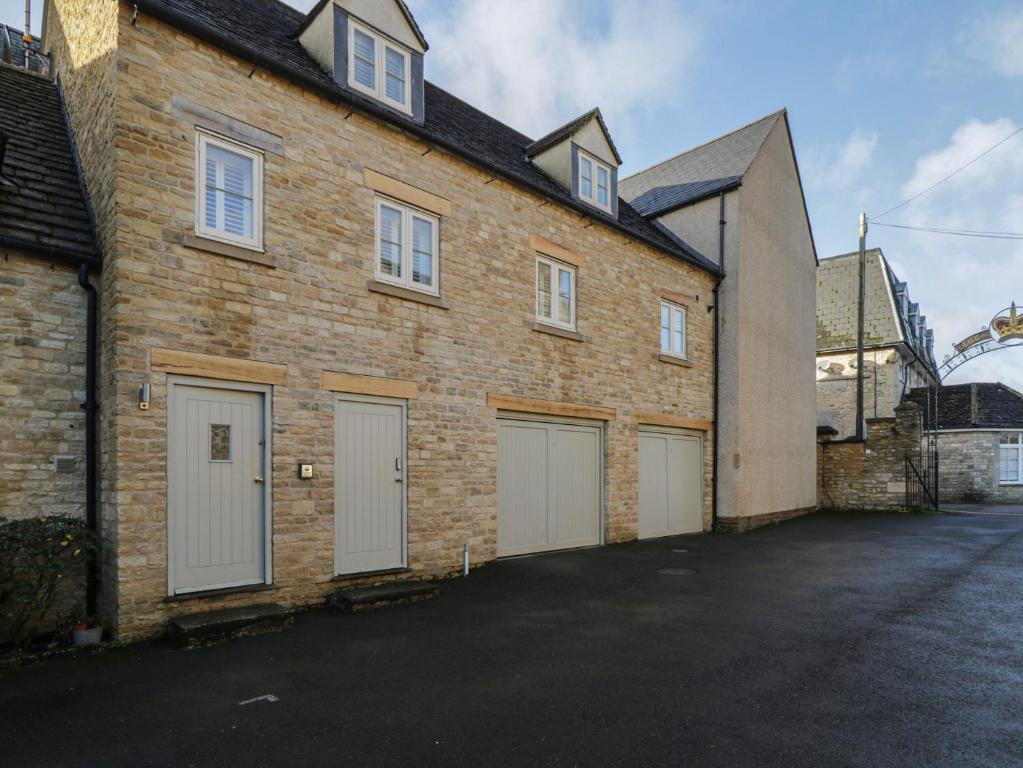 a brick building with white garage doors on it at Flat 6 in Tetbury