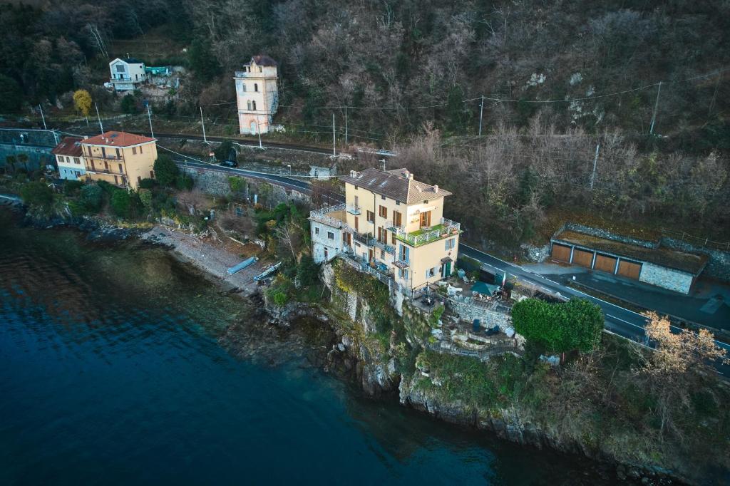 an aerial view of a house on a cliff next to the water at Casa Lago Como in Perledo