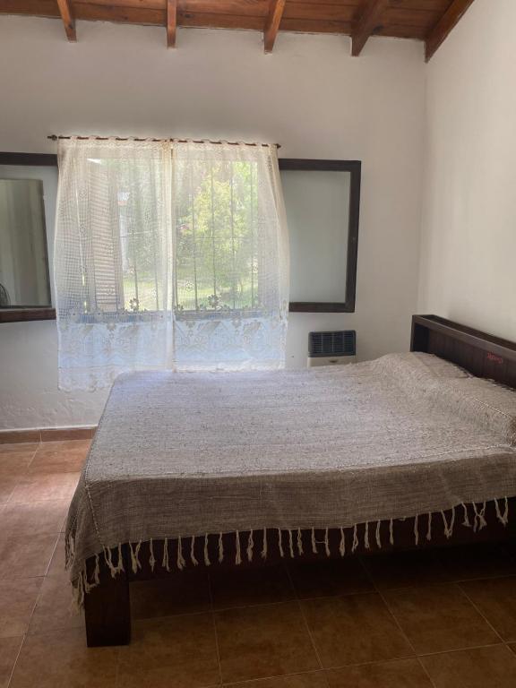 a bedroom with a large bed with a window at Santa Tere in Santa Teresita