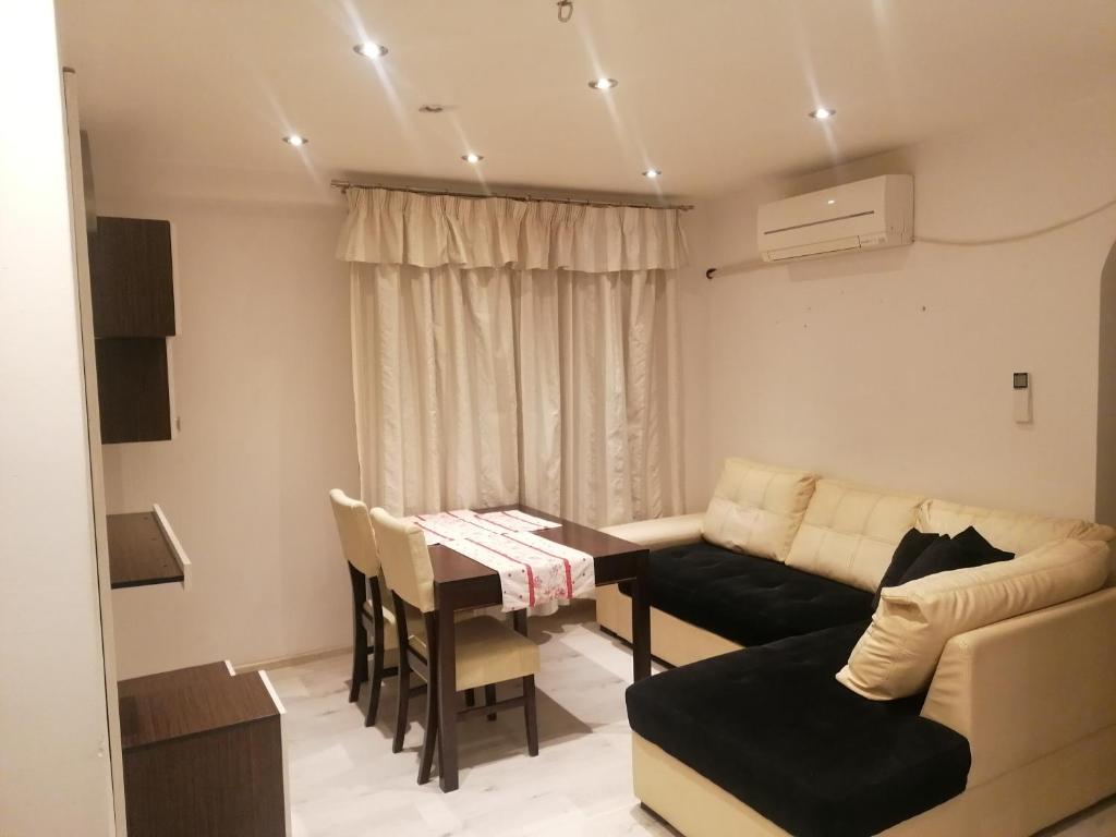 a small living room with a table and a couch at Guest House Plovdiv in Plovdiv