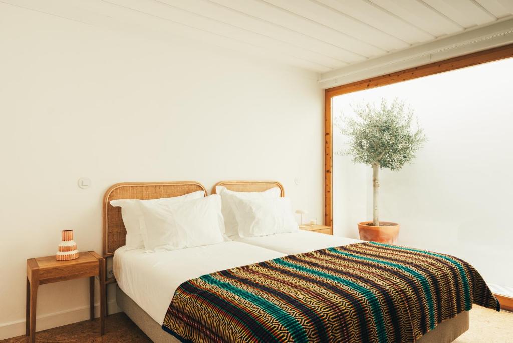 Ένα ή περισσότερα κρεβάτια σε δωμάτιο στο Pateiro da Silva Family Farmers