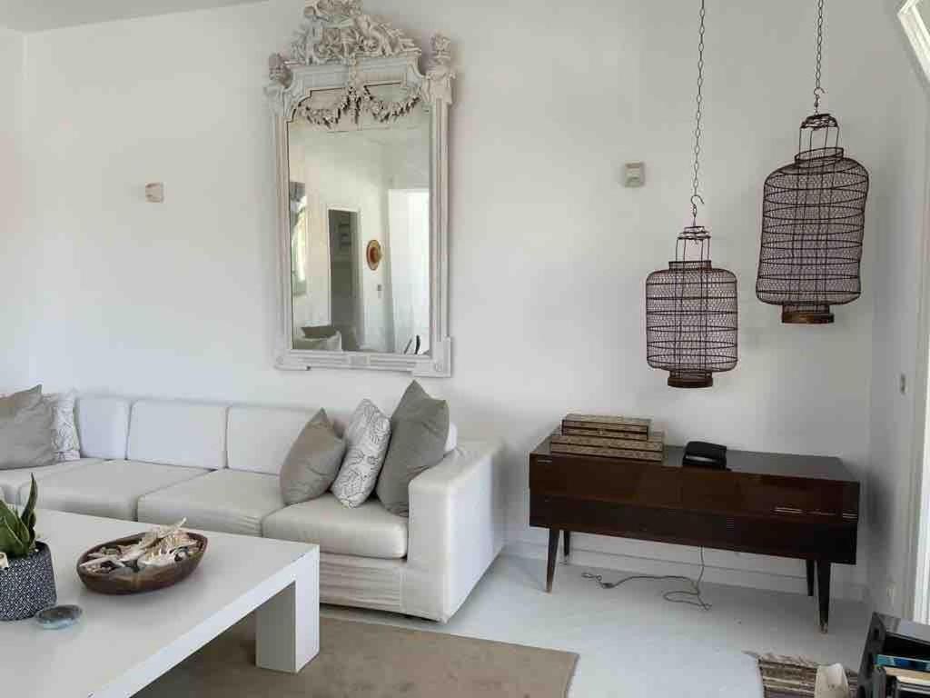 The White House 1 في آنذروس: غرفة معيشة بها أريكة ومرآة وبيانو