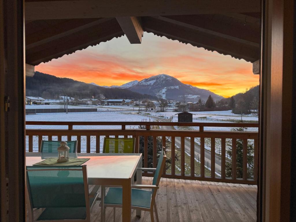 a view from a balcony with a table and a mountain at Apartments Golfweg in Kitzbühel