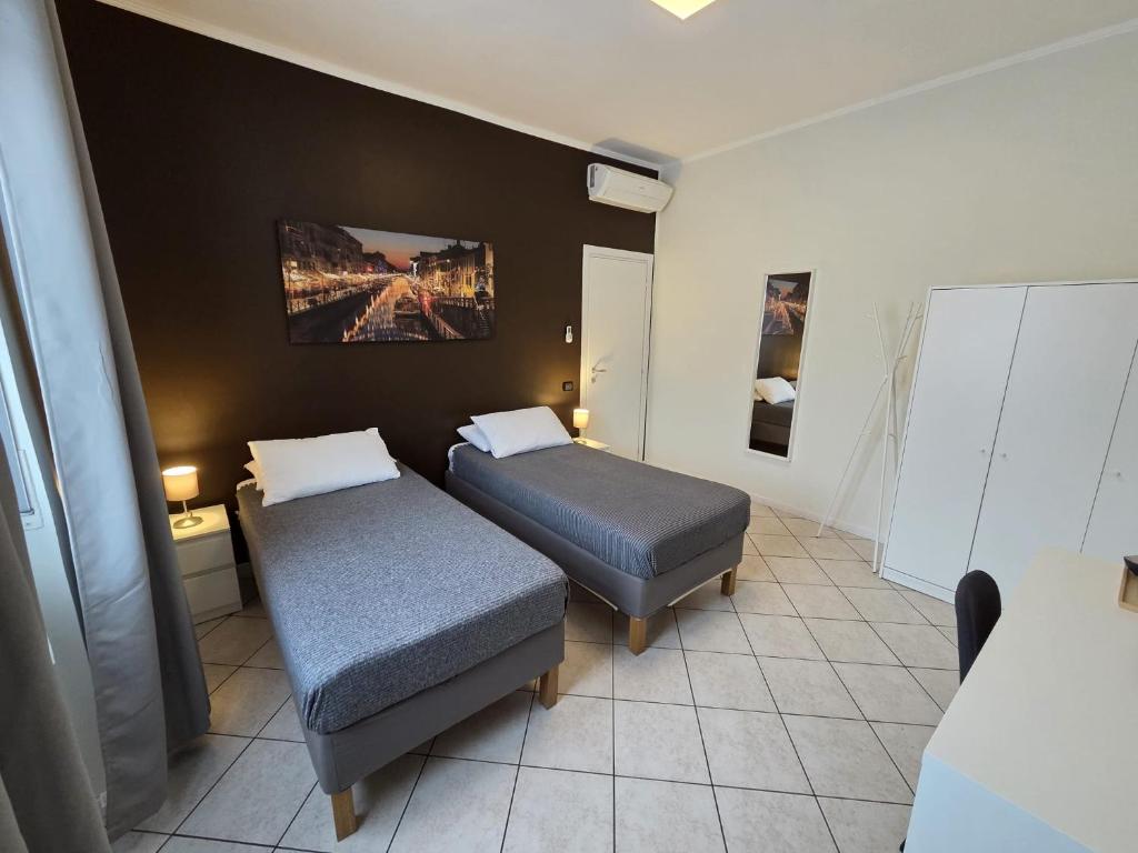 Postel nebo postele na pokoji v ubytování Rho Fiera Flat