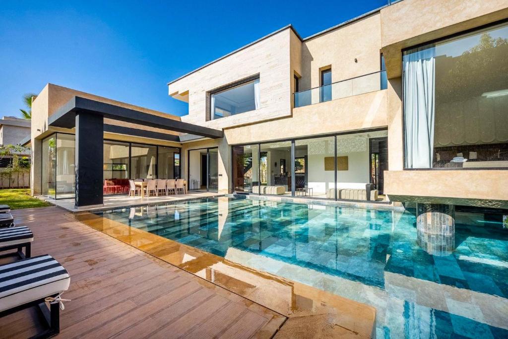 a swimming pool in front of a house at Palais Zahira in Marrakesh