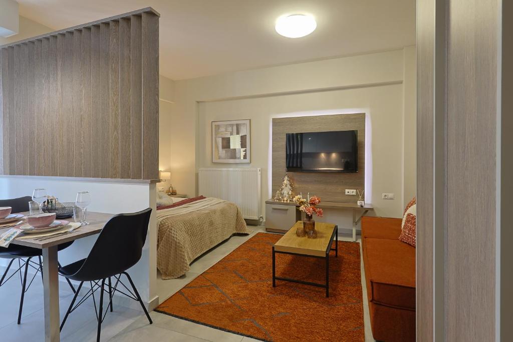 a room with a bed and a table with a dining room at SIGMA - Signature Living & Easy Parking by Optimum Link in Katerini