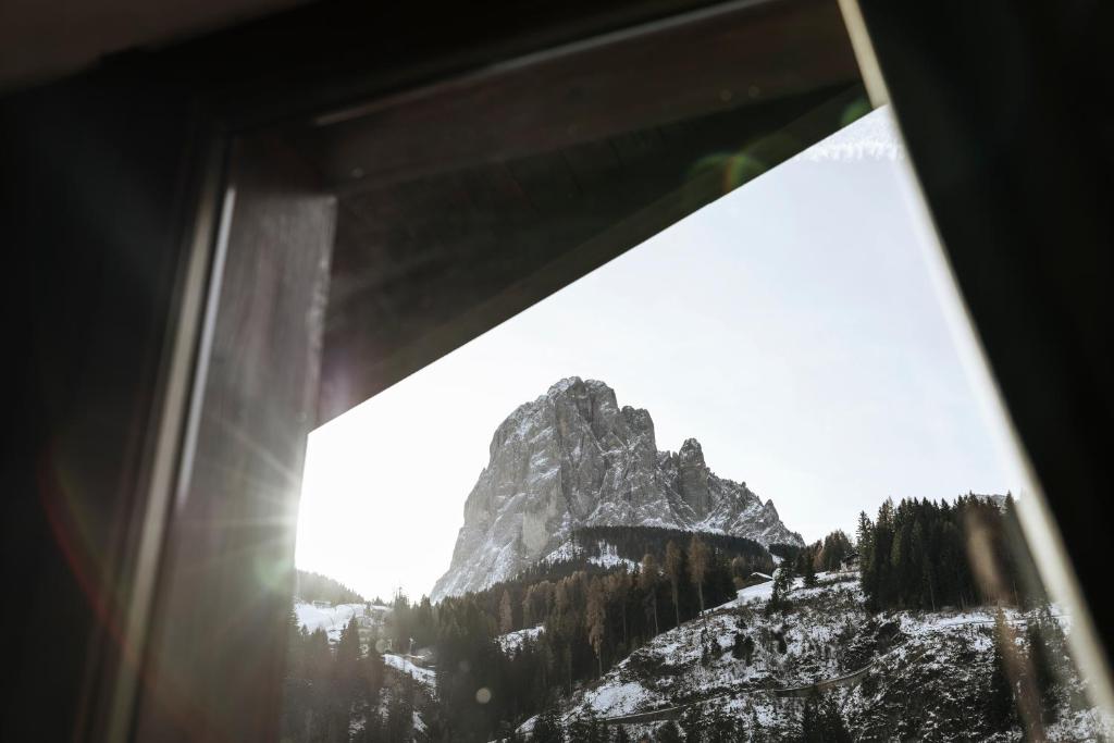 a view of a mountain from a window at La Tambra - Residence - Central with Restaurant in Santa Cristina in Val Gardena