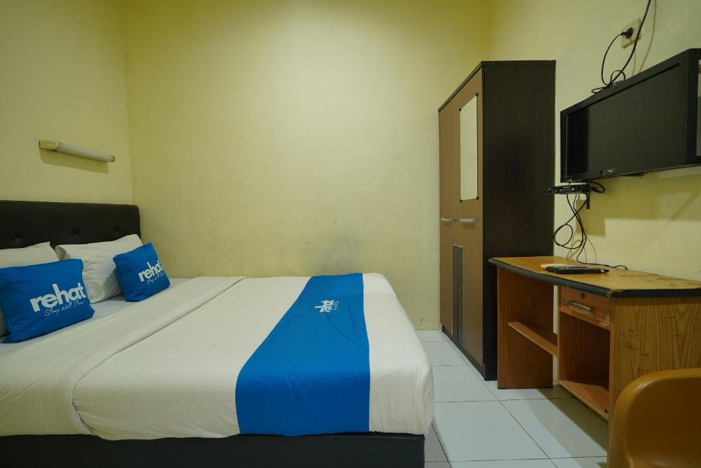 Ένα ή περισσότερα κρεβάτια σε δωμάτιο στο Rehat at Wahidin Guest House