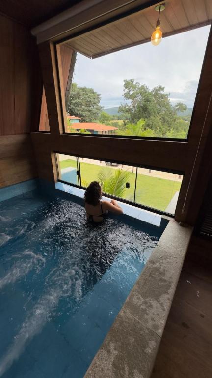 a person in a swimming pool in a house at Pousada Dona Bili in Pirenópolis