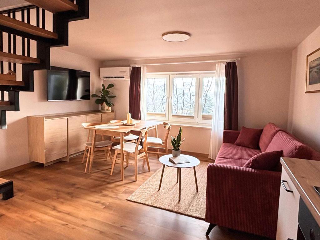 a living room with a couch and a table at Domek przy czerwonym szlaku - The Red Trail Cabin in Węgierska Górka