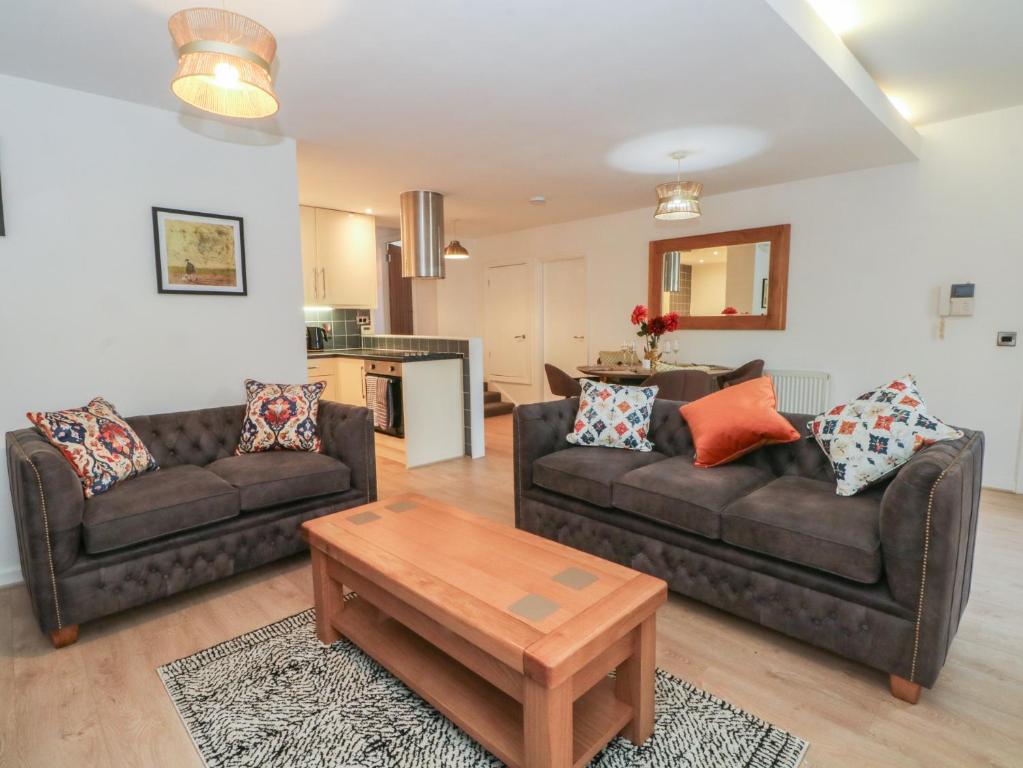 a living room with two couches and a coffee table at 32A Bank Street in Rossendale