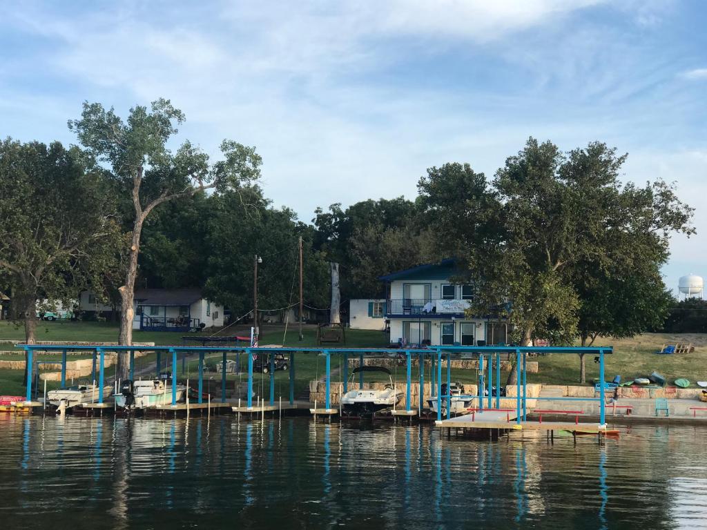 a dock on a lake with a house in the background at Valentine Lakeside in Kingsland