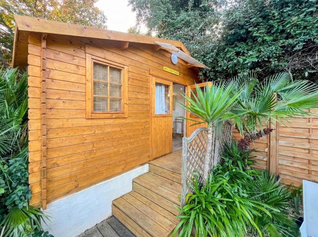 a wooden cabin with a staircase leading up to it at MY Tropézienne in Saint-Tropez
