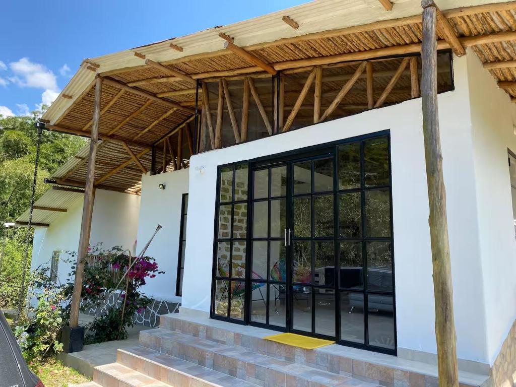a house with a wooden roof at Finca El Cural in Sasaima