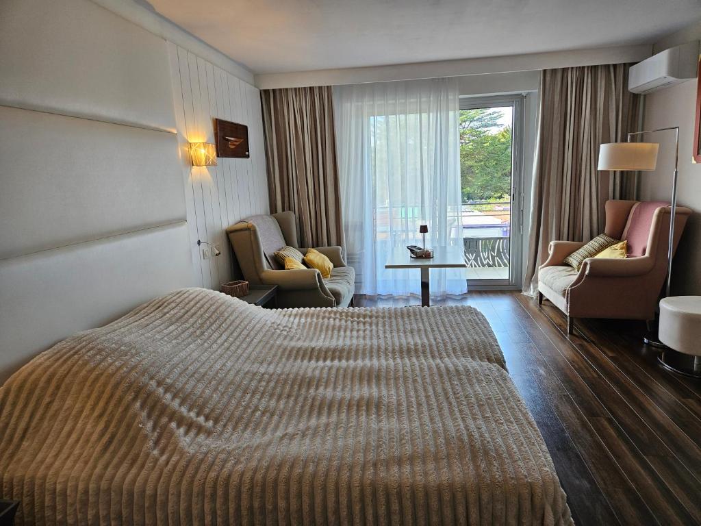 a hotel room with a large bed and a living room at studio, Anglet Chiberta ocean golf surf in Anglet