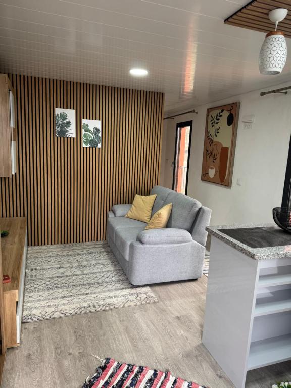 a living room with a couch and a table at O Refúgio in Calheta