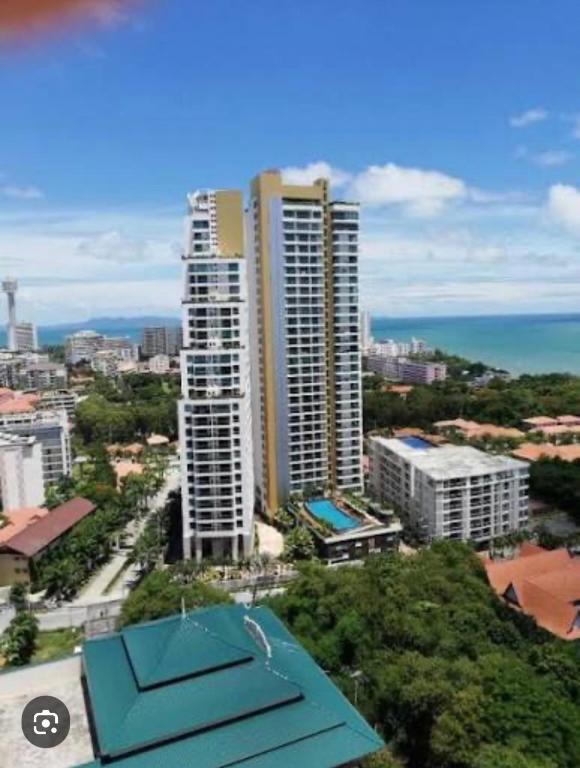 a view of a city with tall buildings and the ocean at Sea View Studio in Pattaya South