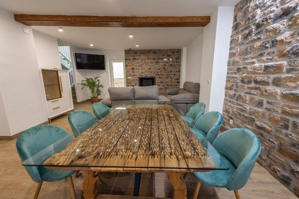 a dining room with a wooden table and blue chairs at Pico Mágina in Albanchez de Magina