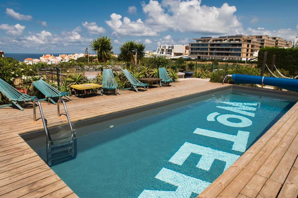 a swimming pool on a deck with lounge chairs and the word end at WOT Ericeira Surf Social in Ericeira