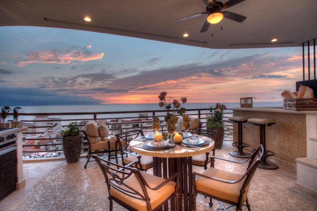 a dining room with a view of the ocean at Pinnacle Resorts 180 in Puerto Vallarta