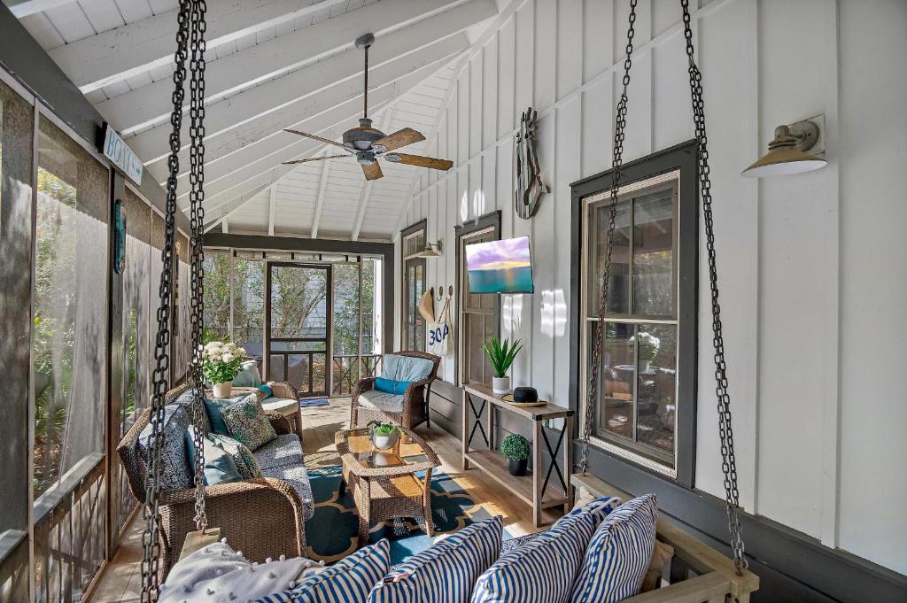 The Magnolia Mermaid في بنما سيتي بيتش: شرفة مع أريكة وكراسي ومروحة سقف
