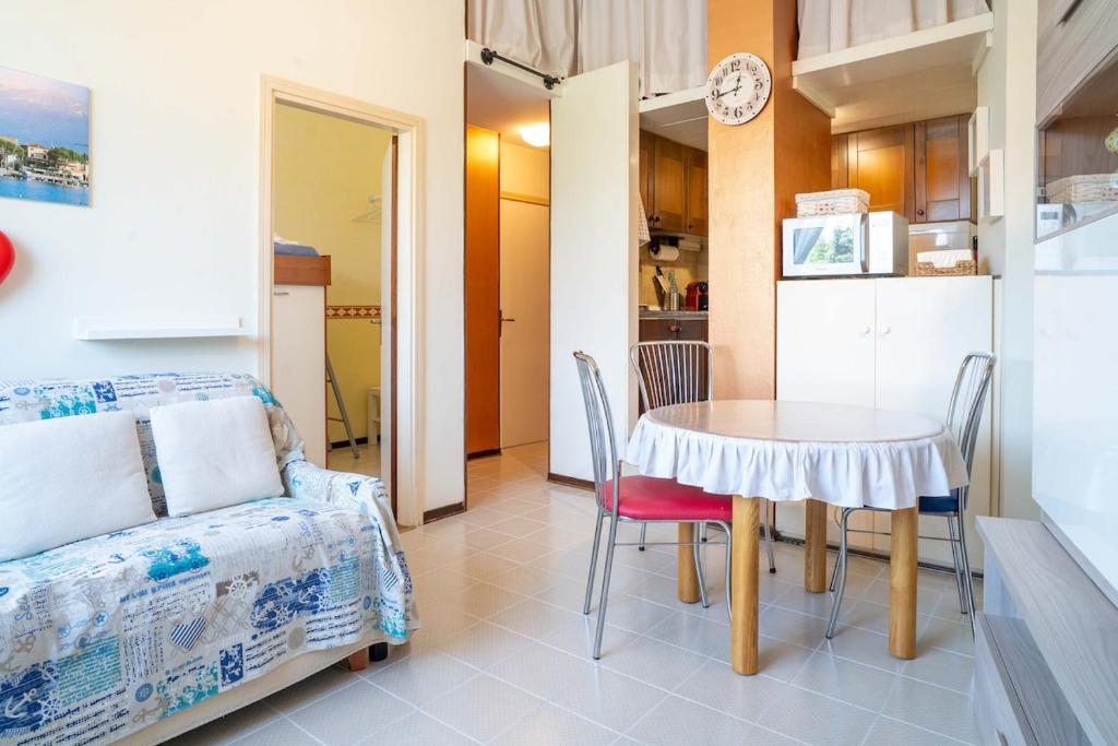 a room with a table and chairs and a kitchen at Riva chiara in Toscolano Maderno