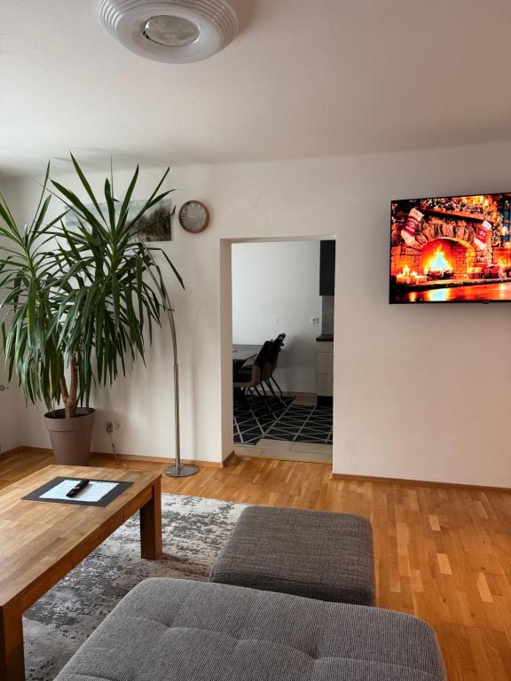 a living room with a couch and a tv on the wall at Wohnung in Hüttau in Sonnberg