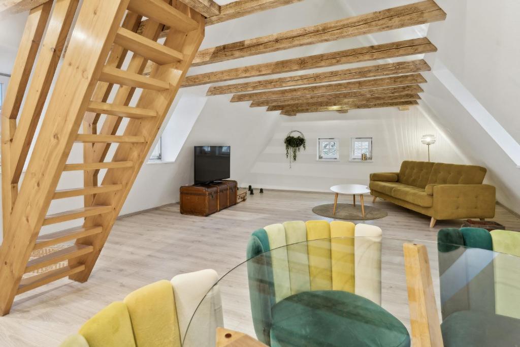 a living room with wooden ceilings and a glass table at "Alte Post" in Münsingen