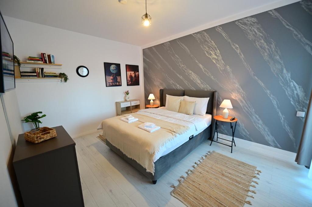 a bedroom with a bed and a large wall at FLH - Moonwalk in Sibiu