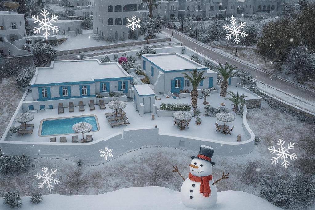 a snowman is standing in front of a house at Ancient Thera Apartments in Kamari